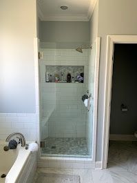 A bathroom with a bathtub and a walk in shower.