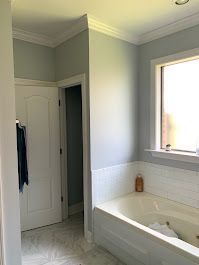 A bathroom with a tub and a window.