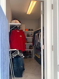 A walk in closet filled with clothes and shoes.