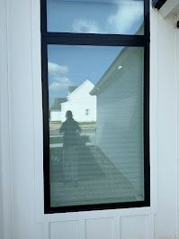 There is a reflection of a person in the window.