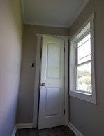 A hallway with a door and a window in a house.