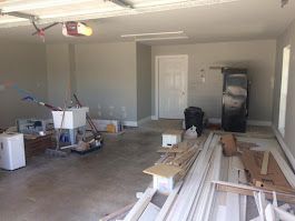 A garage filled with lots of junk and a sink.