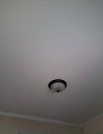 A ceiling light is hanging from the ceiling of a room.