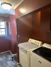 A laundry room with a washer and dryer and a window.