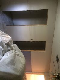 A bedroom with a bed and a ceiling fan.