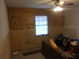 A room with a ceiling fan and a window.