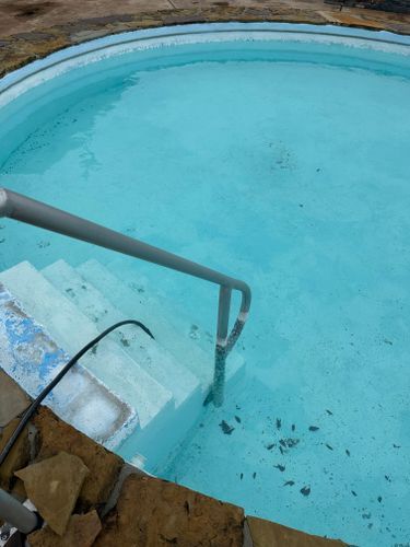 A swimming pool with stairs leading up to it