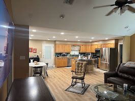 A living room filled with furniture and a ceiling fan.