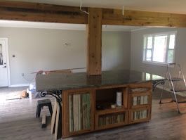A living room with a large island in the middle of it.