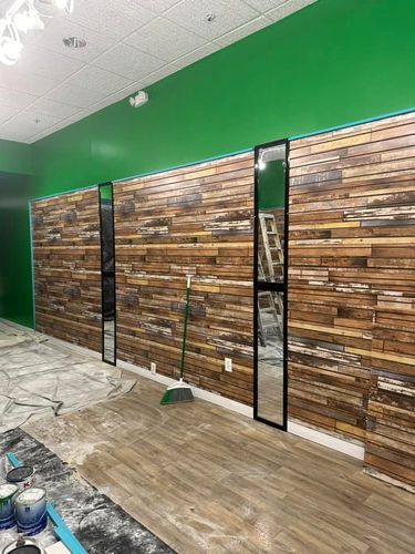 A room with a wooden wall and green walls.