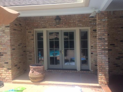 A brick house with a patio and a sliding glass door