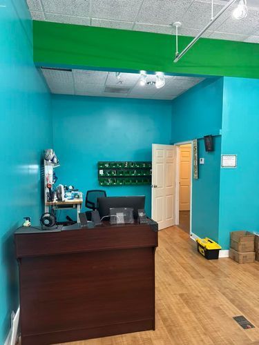 A reception desk in a room with blue walls and a yellow toolbox.