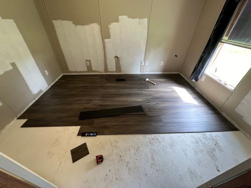 A room with a wooden floor and a window.