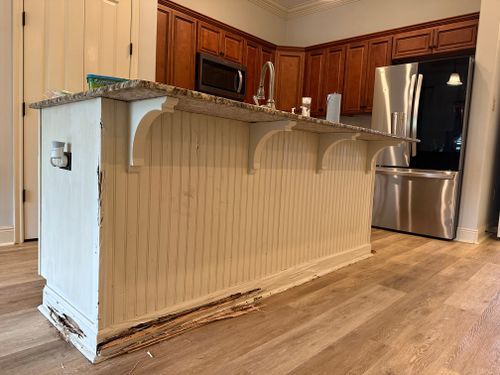 A kitchen with stainless steel appliances and a large island.