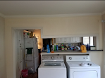 A kitchen with a washer and dryer in it.