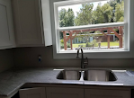 A kitchen with a sink and a window.