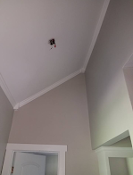 A room with a door and a ceiling with a light on it.