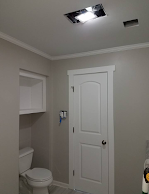 A bathroom with a toilet , sink , and door.