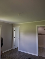 A room with a ceiling fan and a door leading to a bathroom.