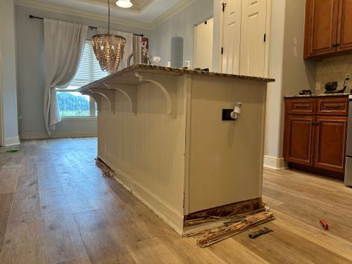A kitchen with a large island in the middle of the room.