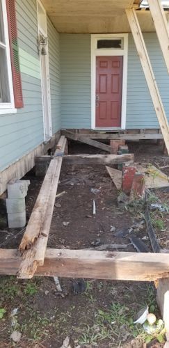 A porch is being built on the side of a house.