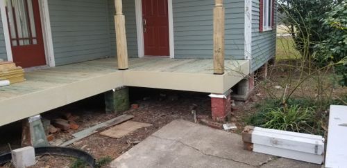 A porch is being built on the side of a house.