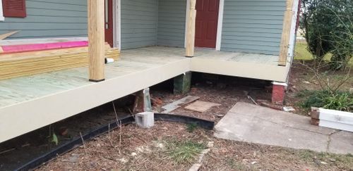 A porch is being built on the side of a house.
