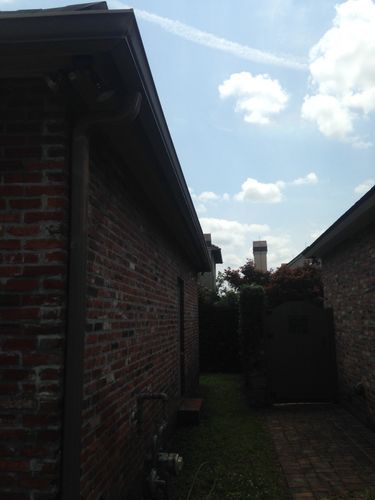 A brick house with a chimney in the backyard.
