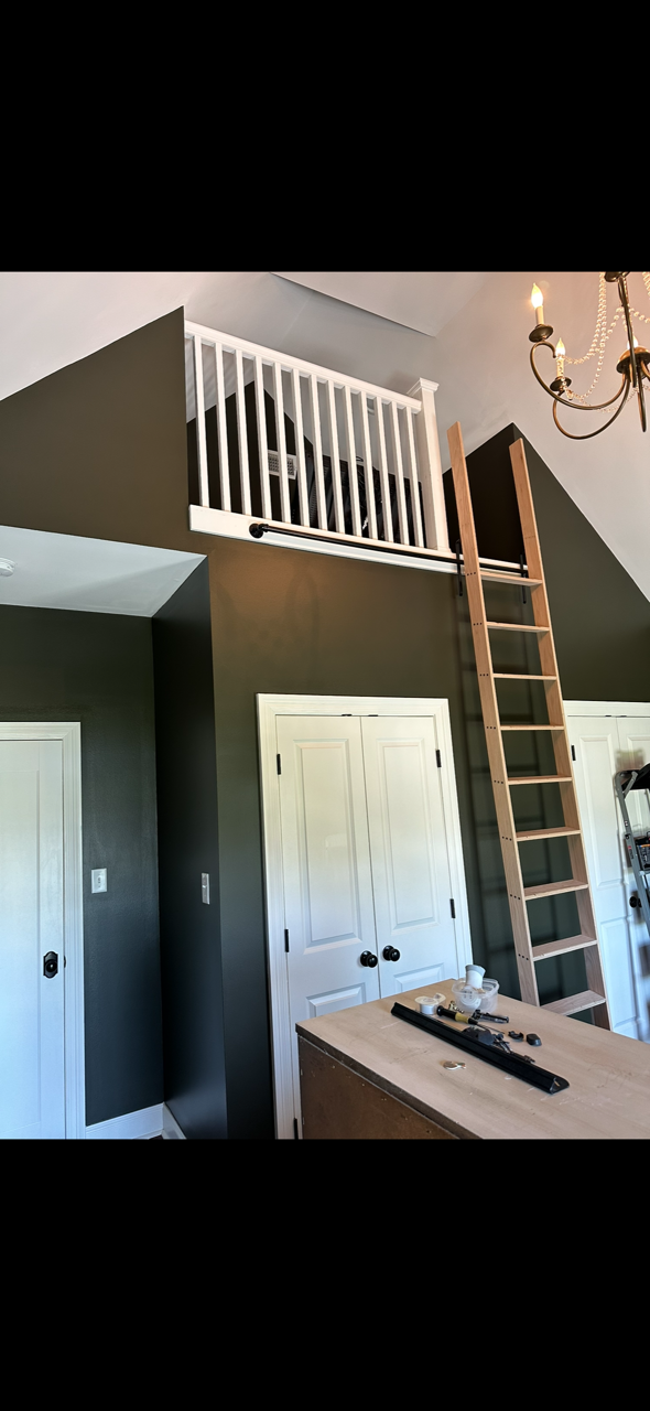 A backyard with a wooden fence and a patio.