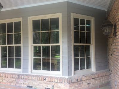 A house with a lot of windows and a brick wall.