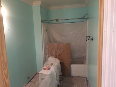 A bathroom with a tub and shower being remodeled.