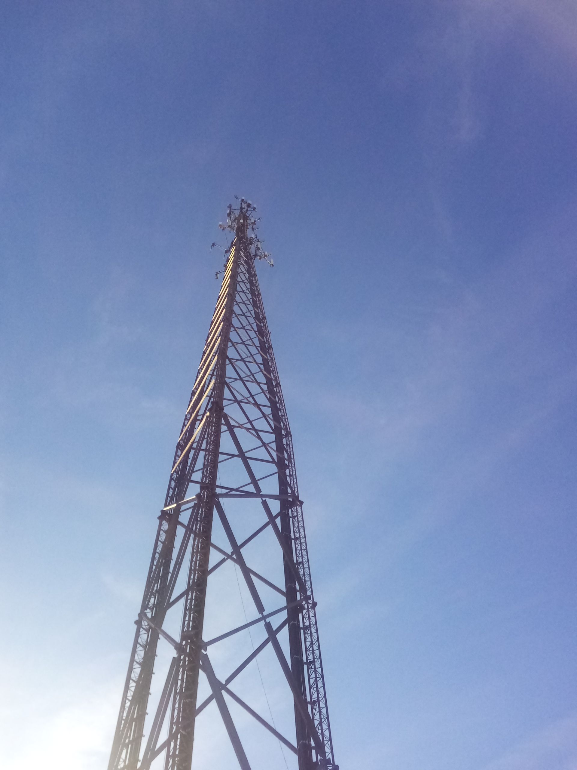A very tall metal tower against a blue sky