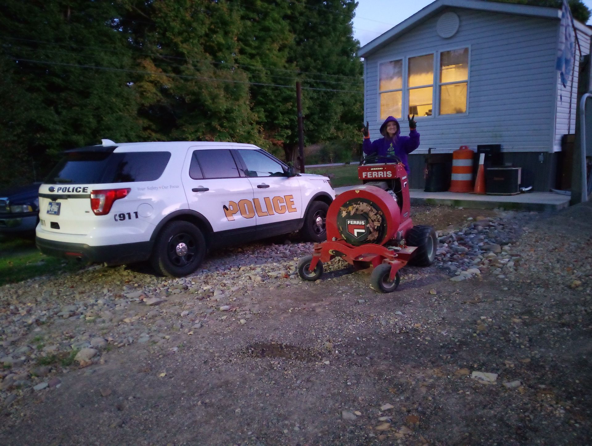 A police car is parked in front of a mobile home