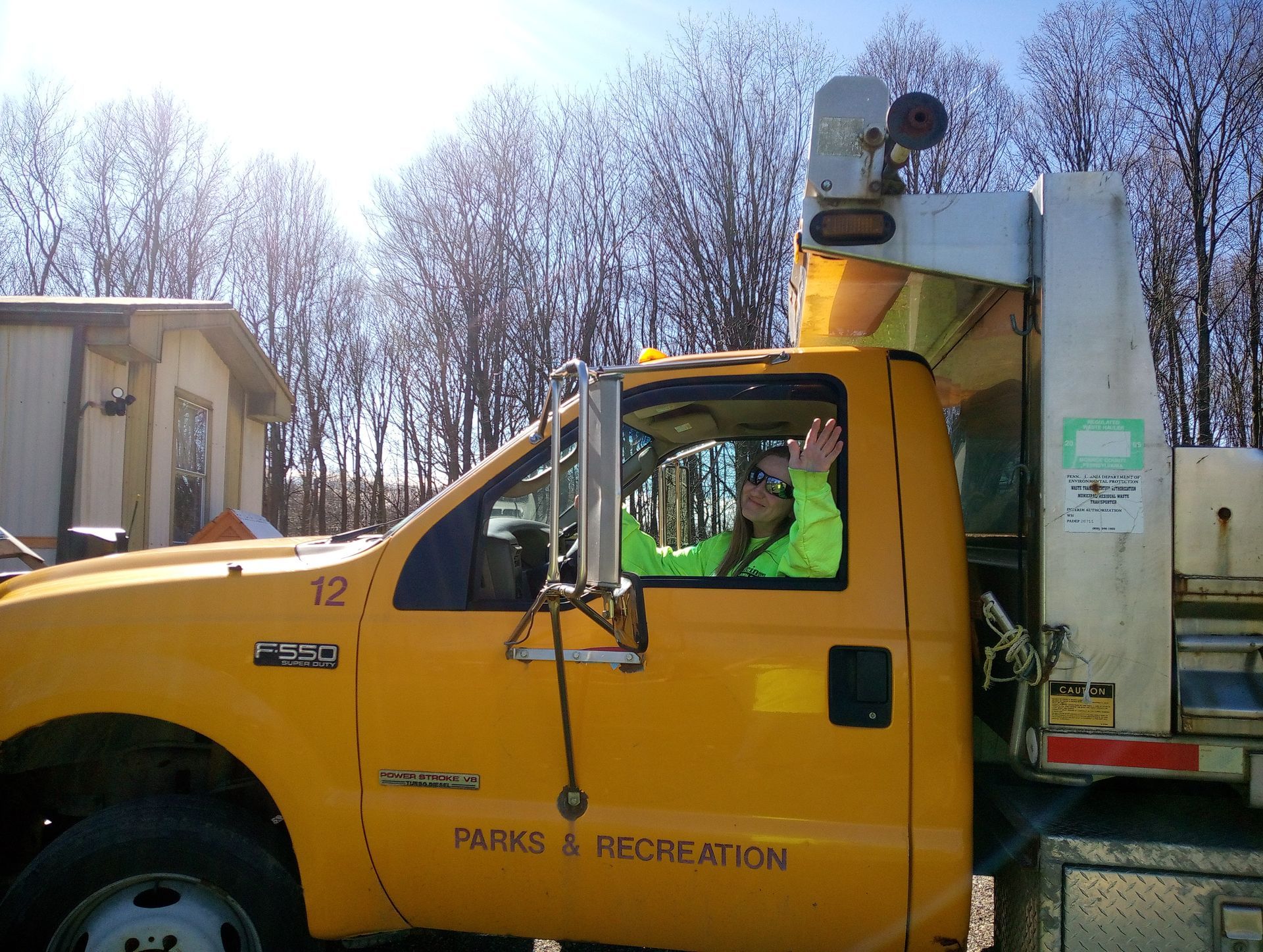 A yellow truck that says parks and recreation on the side