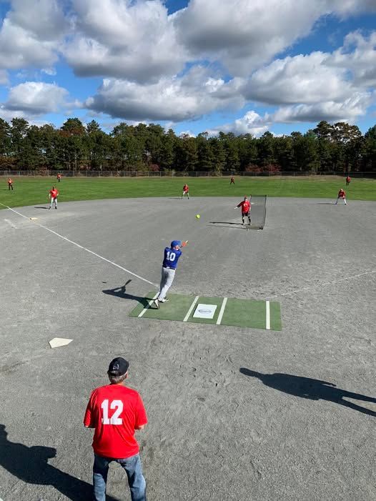 Baseball player sliding into home plate, catcher in front. Blue and gold uniforms, action shot.