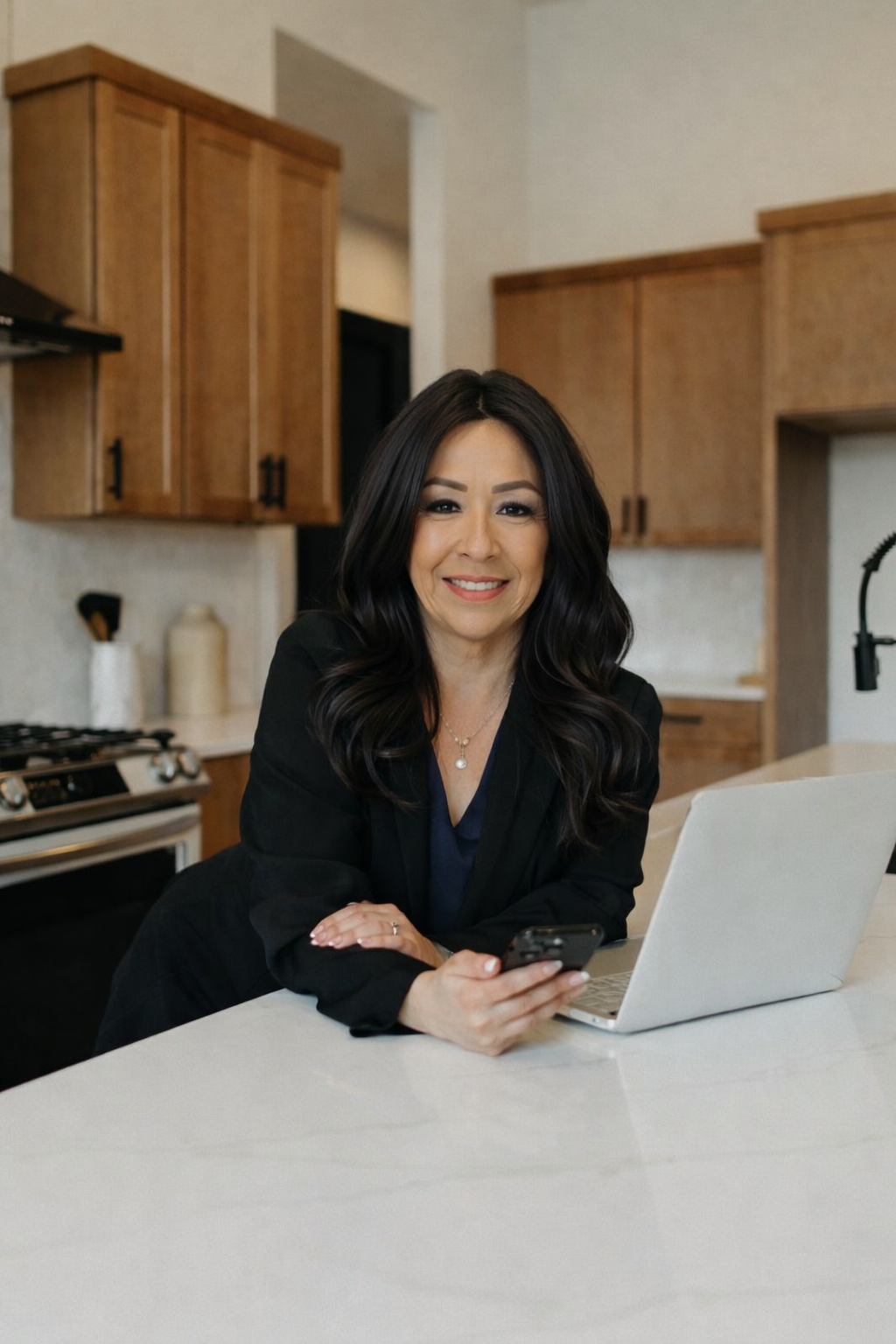 A living room with a couch and a wooden table with a vase of flowers on it.