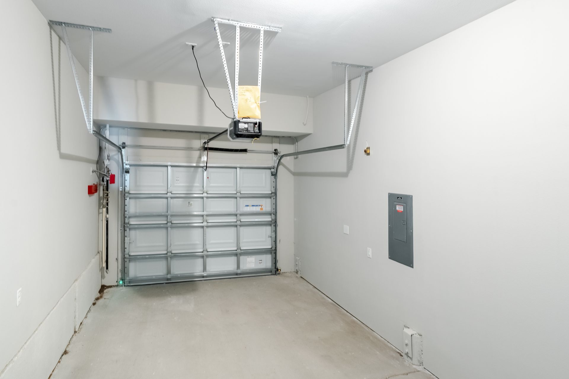 an empty garage with a garage door open and a garage door opener