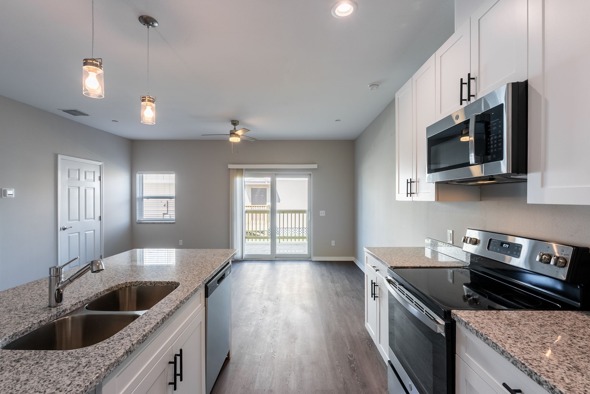 a kitchen with granite counter tops and stainless steel appliances