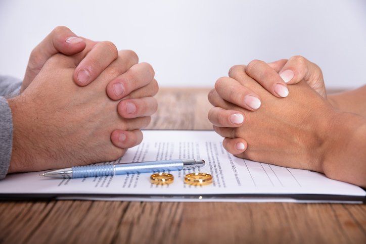 Couple's Hands With Divorce Agreement - Divorce in Orland Park, IL