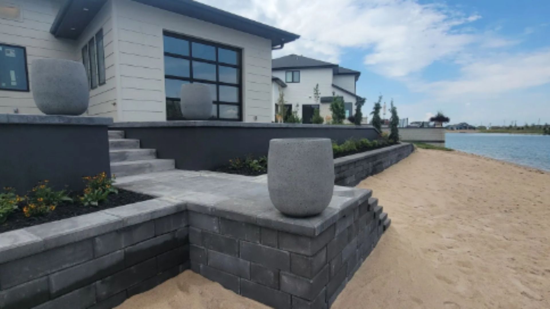 Custom patio and retaining wall for Hardscaping Omaha NE homes by Garret’s Lawn Services