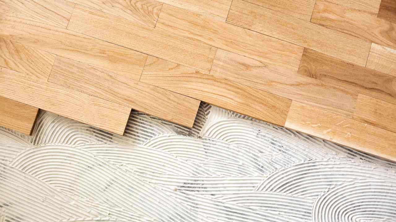 Close-up image of a wooden floor being installed.