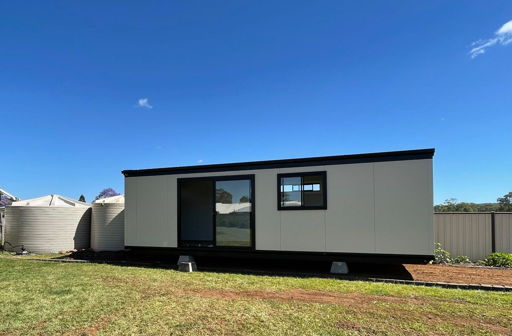 Man Standing in Front of a Tiny House — Professional Tiny House Builders in Nanango, QLD