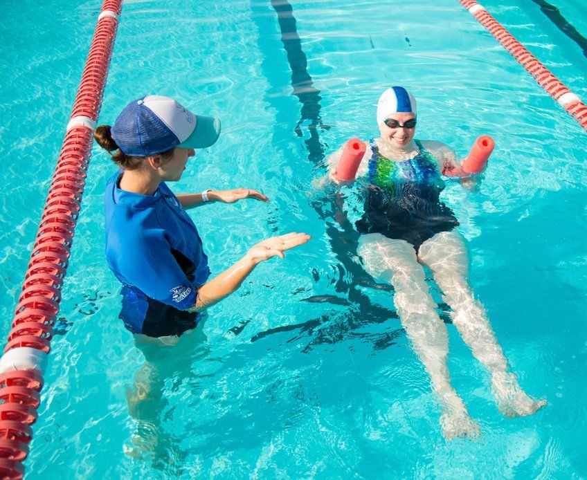 Instructor helping swimmer