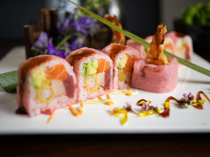 A close up of a plate of sushi on a table.
