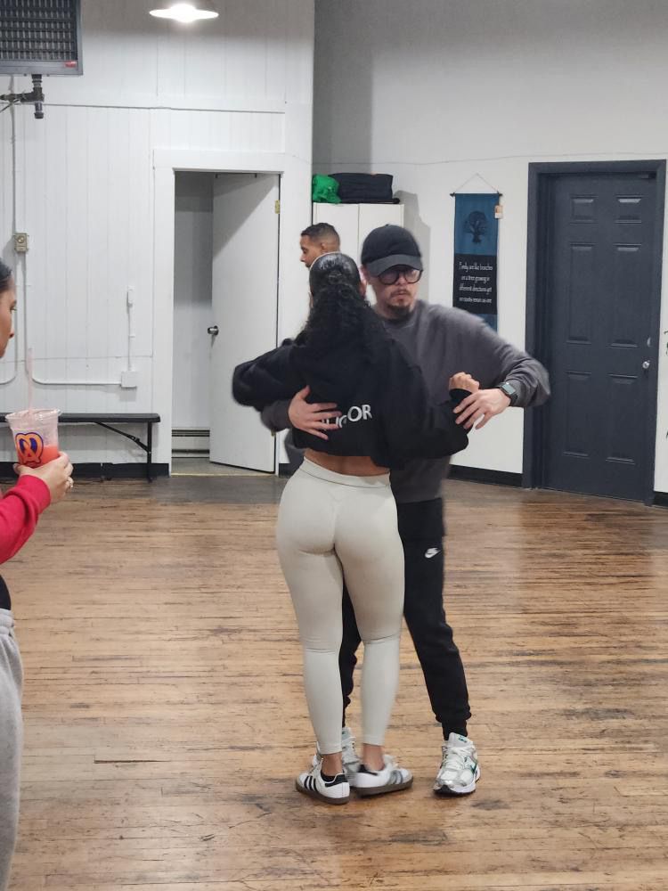 Instructor Brandon dances Kizomba partnerwork choreography with his fellow female instructor.