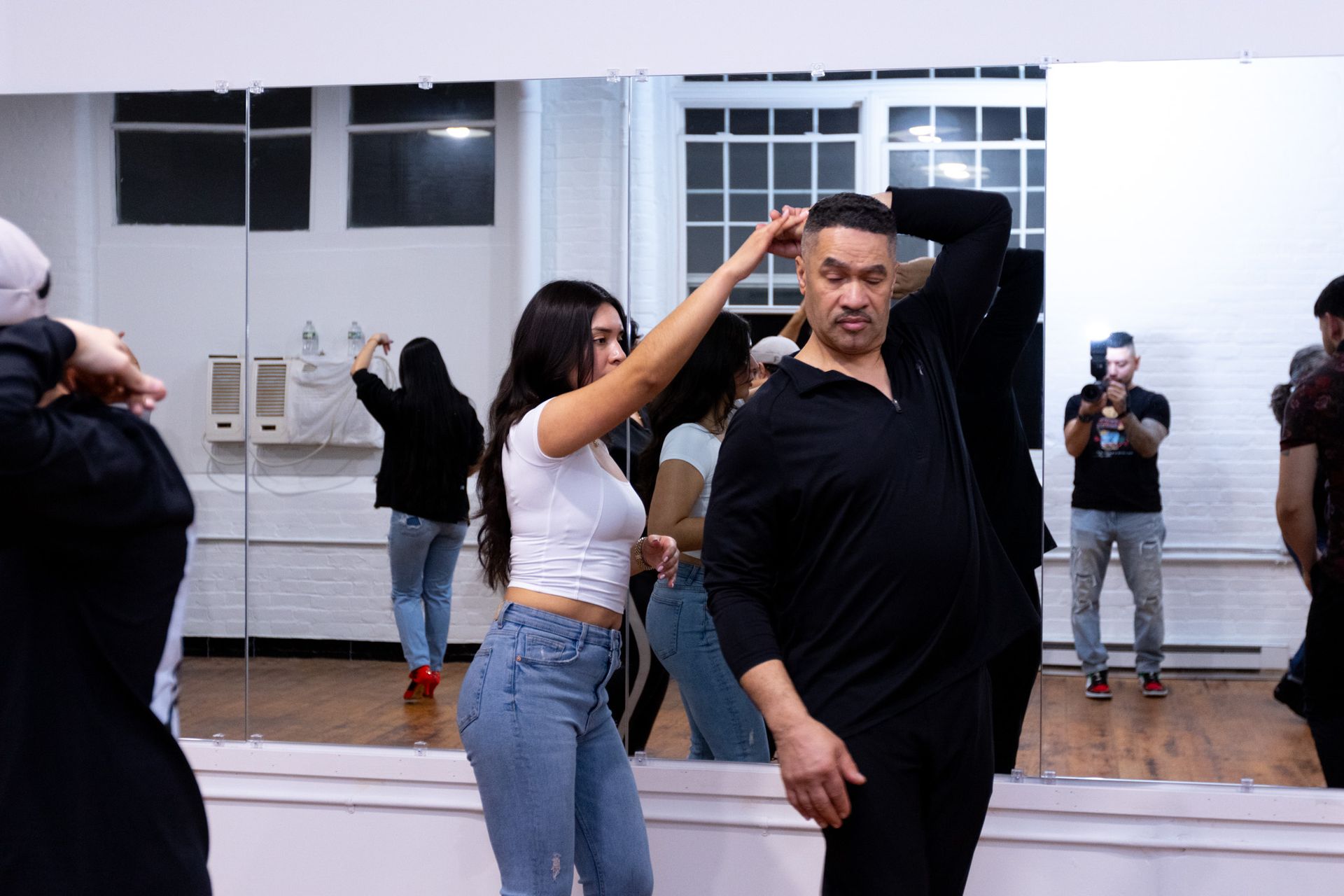 A man spins his female dance partner during a Bachata class.