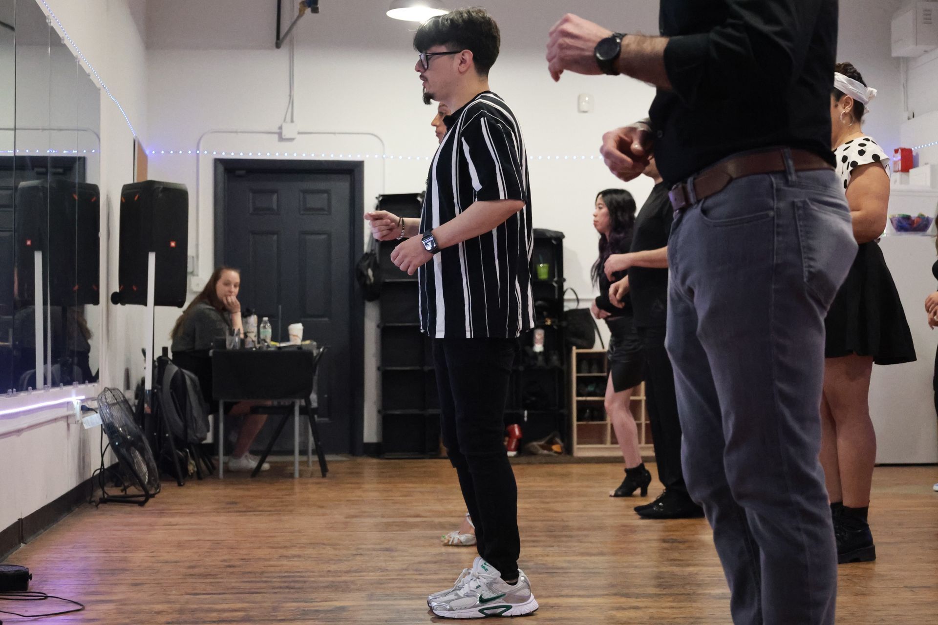 Instructor Brandon explains choreography to his students at a Kizomba workshop.