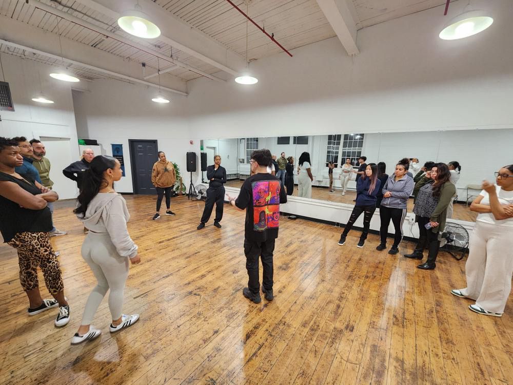 Instructor Brandon speaks to his students during a Kizomba class.