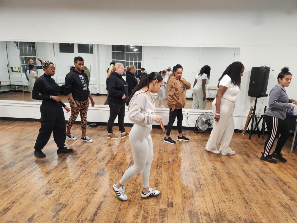 Kizomba students practice their footwork choreography during class.