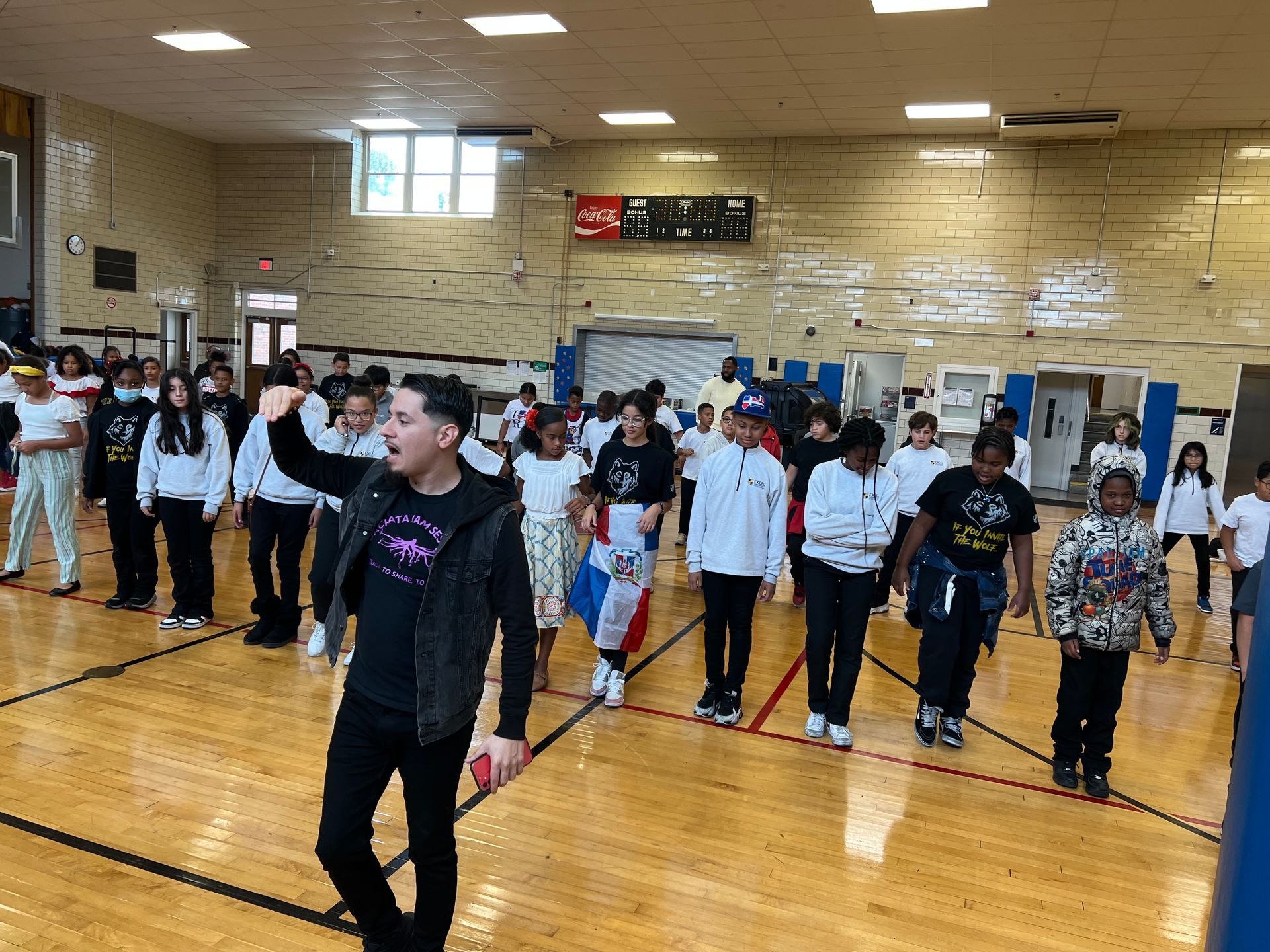 Brandon Contreras, Cultura Dance Arts founder, instructs a group of middle school aged students during a school workshop.